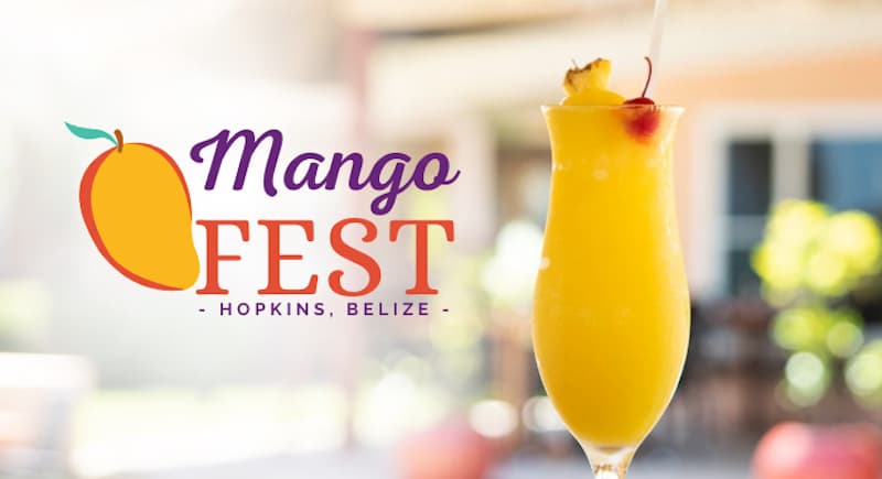 A vibrant mango drink sits in front of the "Mango Fest" logo, representing an event in Hopkins, Belize.