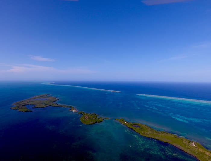 A breathtaking aerial shot of Glover's Reef a southern reef, one of the largest barrier reefs in the Western Hemisphere.