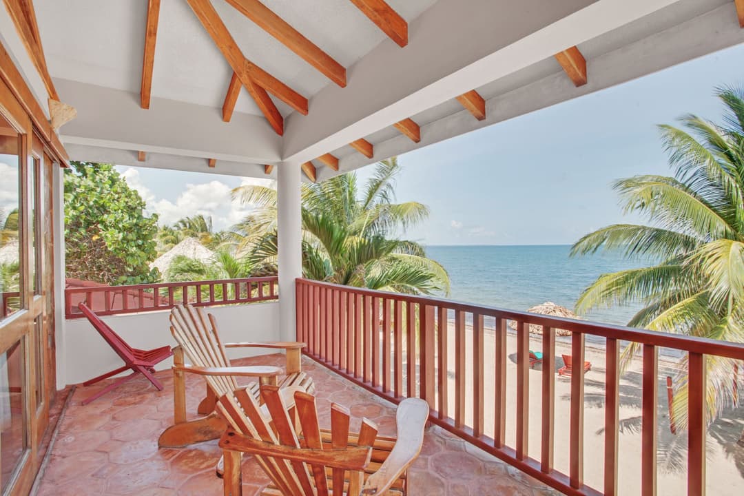 Oceanfront balcony with chairs overlooking the beach