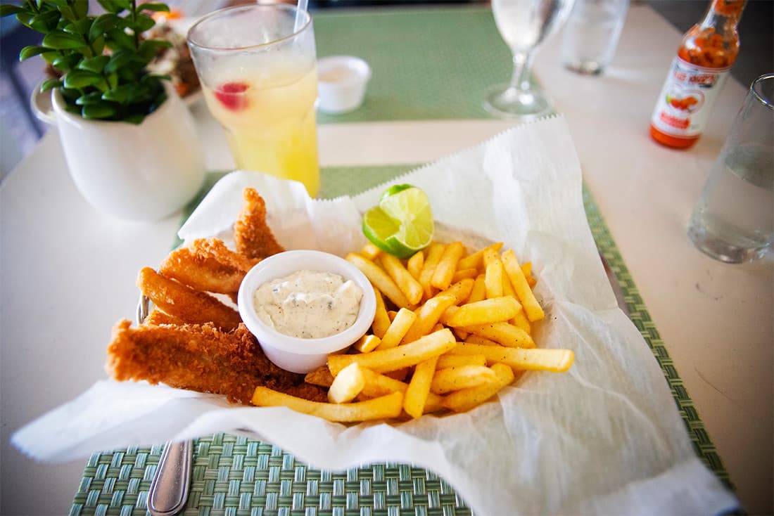 Fried Fish and Fries in a basket with lemonade.