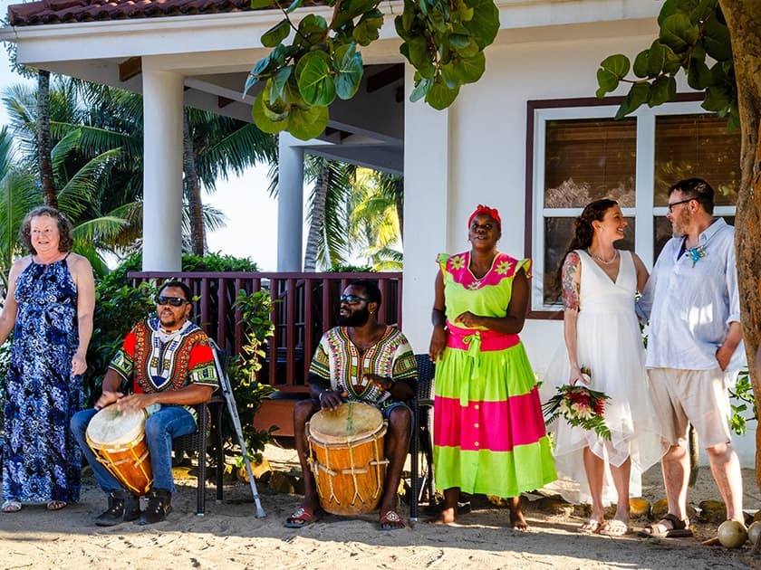 A multicultural group celebrates a wedding outdoors with drummers and vibrant attire. A multicultural group celebrates a wedding outdoors with drummers and vibrant attire.