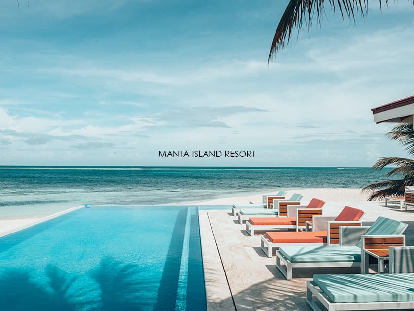 A serene poolside view at Manta Island Resort overlooking the ocean.
