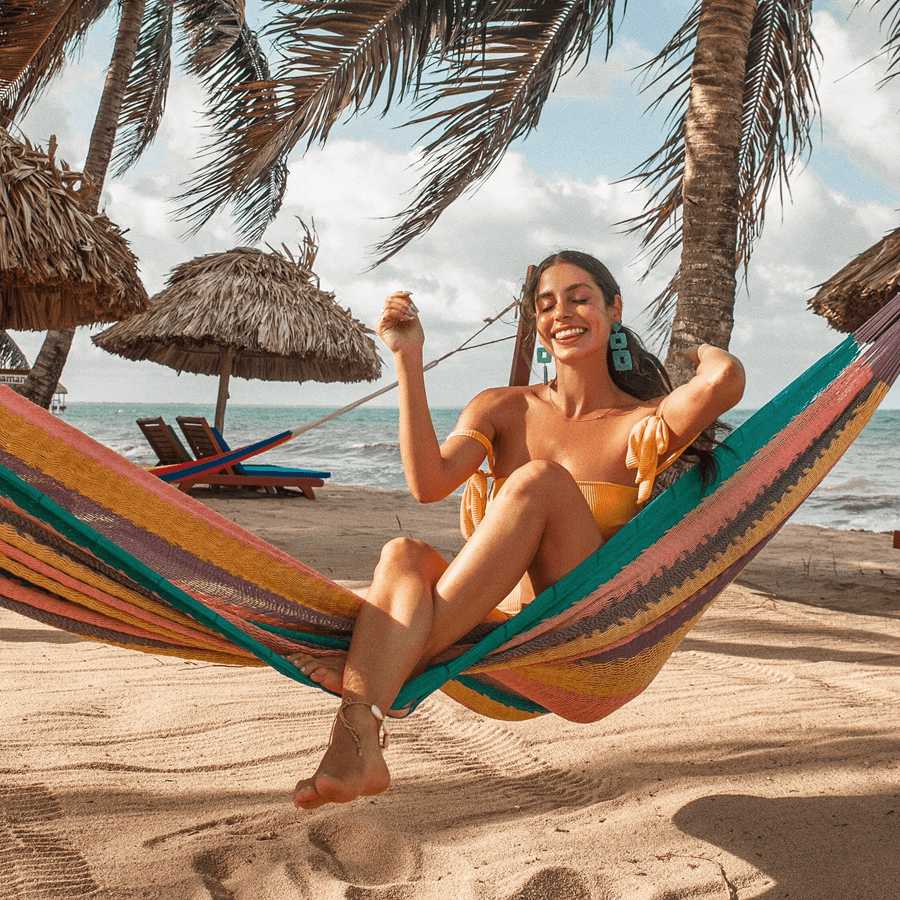 Guest relaxing in a hammock by the Caribbean