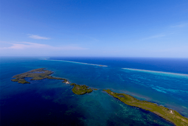 Aerial view of a coastal landscape featuring turquoise waters and small islands.