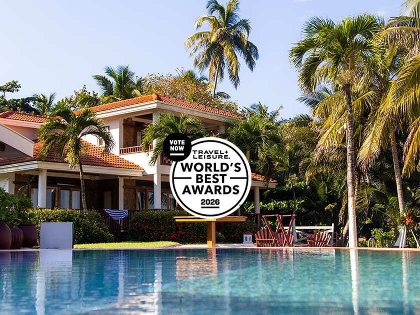 A luxurious villa surrounded by palm trees and a swimming pool, featuring a promotional banner for Travel + Leisure's World's Best Awards 2026. A luxurious villa surrounded by palm trees and a swimming pool, featuring a promotional banner for Travel + Leisure's World's Best Awards 2026.