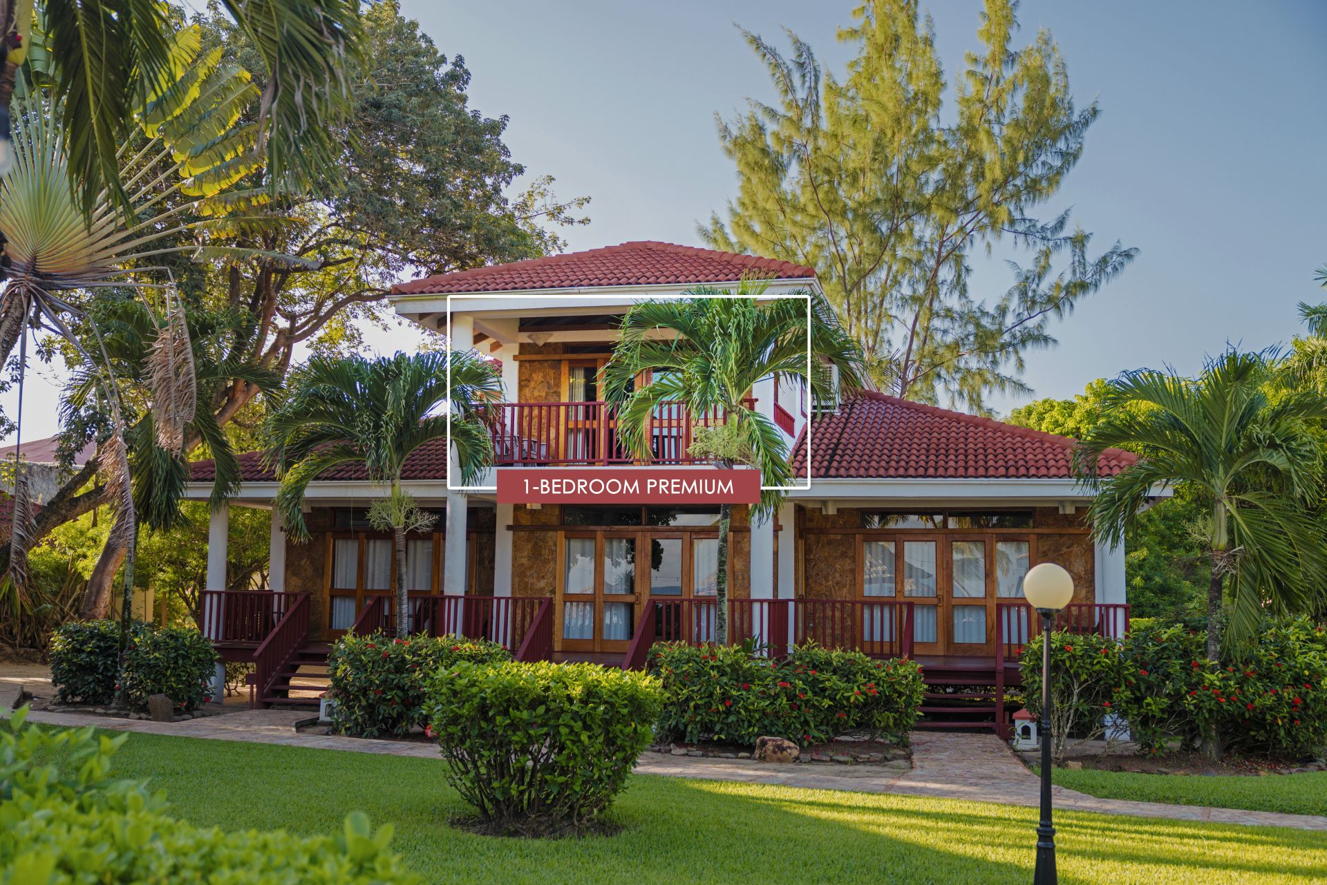 The image shows a 1-bedroom premium room at Belizean Dreams.