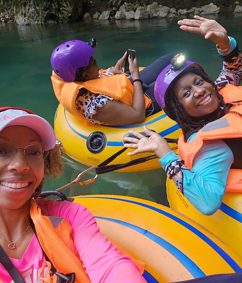 Women experiencing cave tubing in Belize.