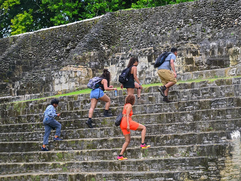 Group climbing a Mayan Ruin in Belize.