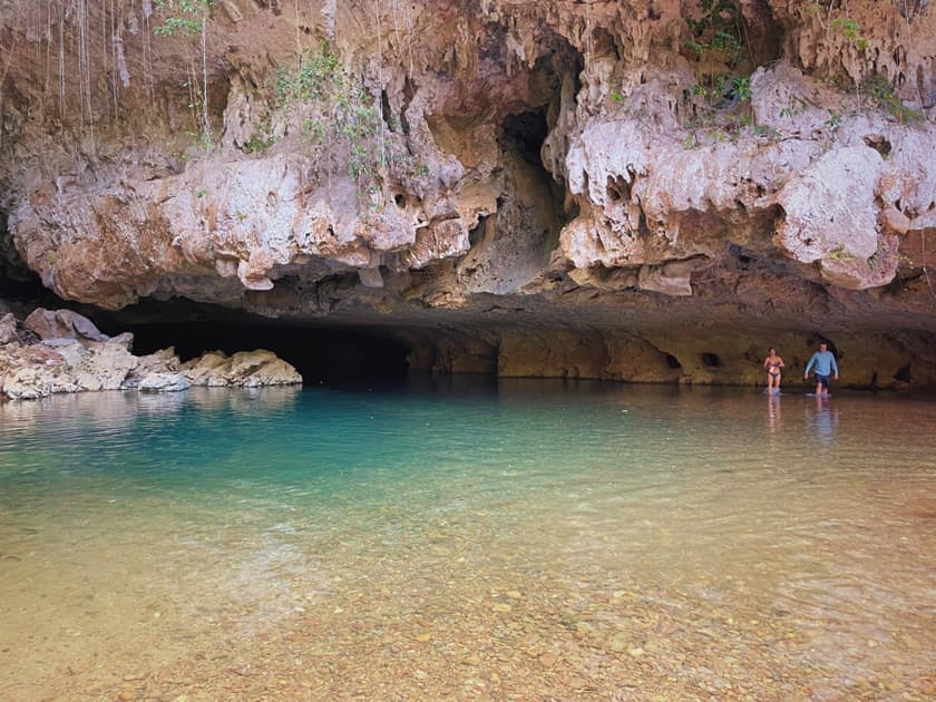 Adventurous cave swimming excursion in Belize with crystal-clear water and limestone formations